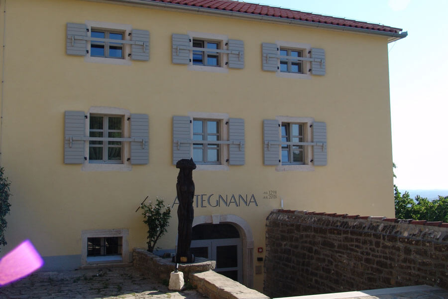 Artegnana 1798 front facade with wooden sculpture and stone entrance