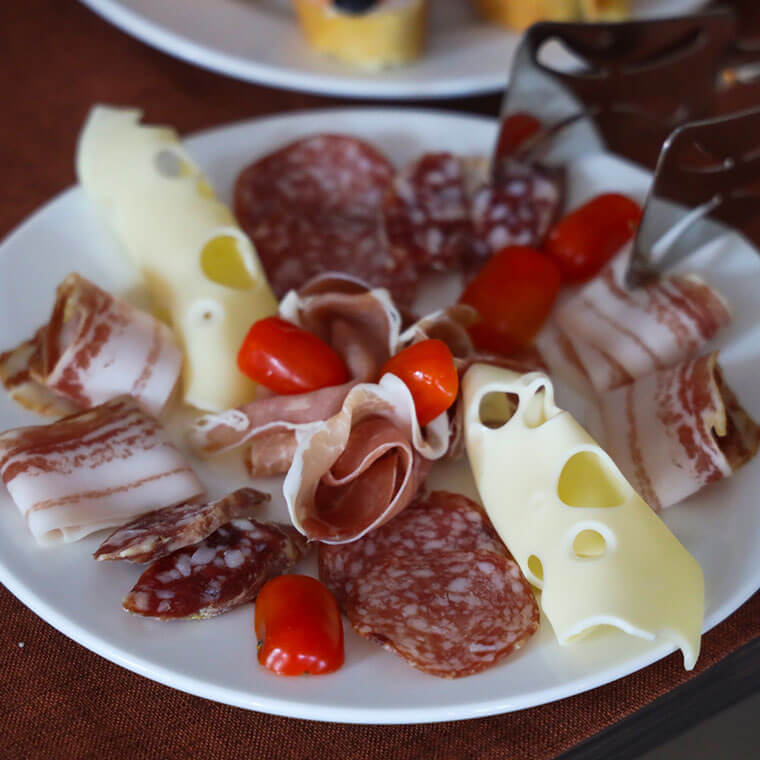 Plate of Istrian charcuterie with prosciutto, salami, pancetta, cheese and cherry tomatoes