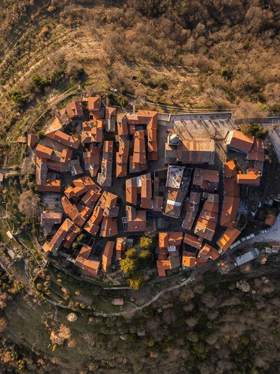 Aerial drone view of Grožnjan medieval hilltop town with clustered terracotta rooftops
