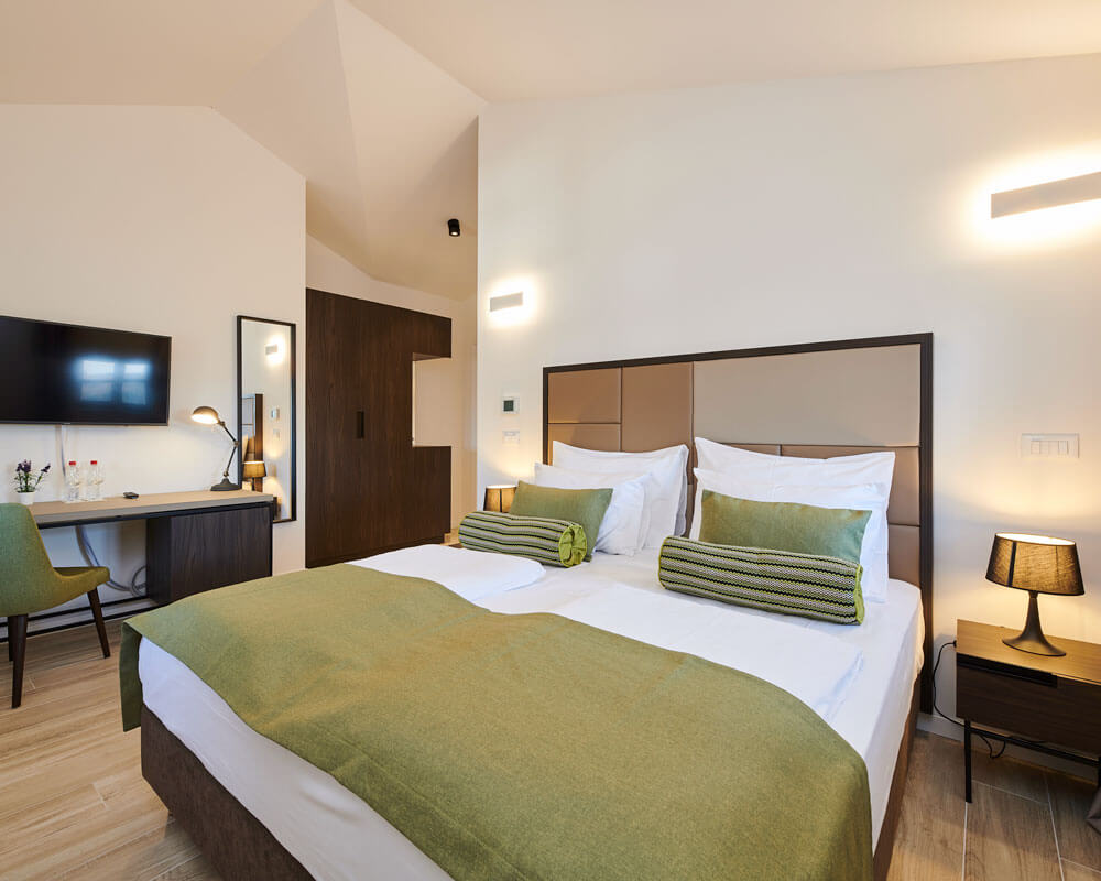 Superior Double Room with olive green accents, high ceiling and warm lighting at B&B Artegnana 1798